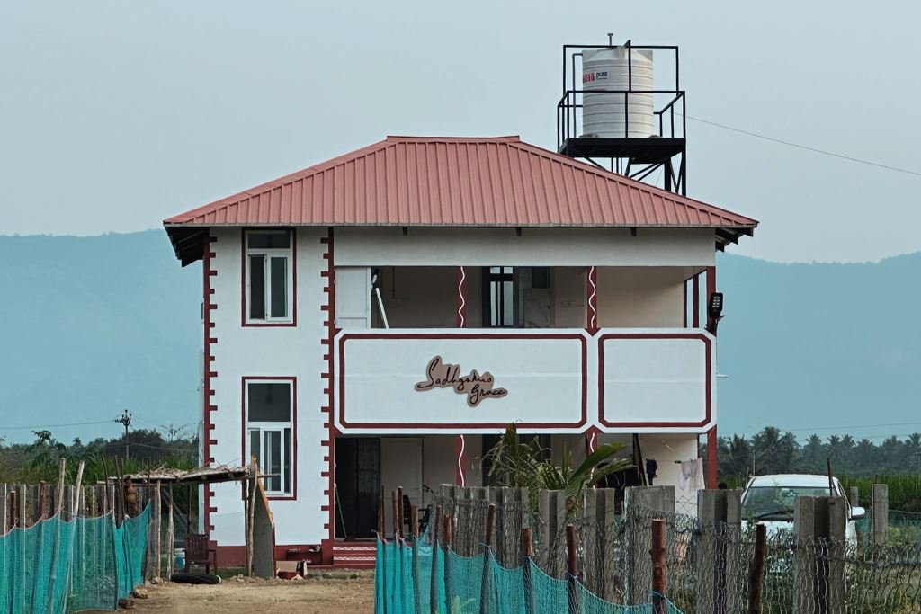 Sadhguru's Grace homestay building with Velliangiri mountains behind